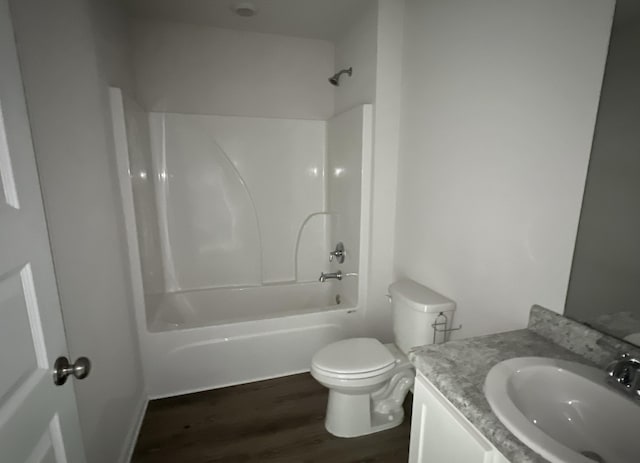 full bathroom with washtub / shower combination, vanity, toilet, and wood finished floors