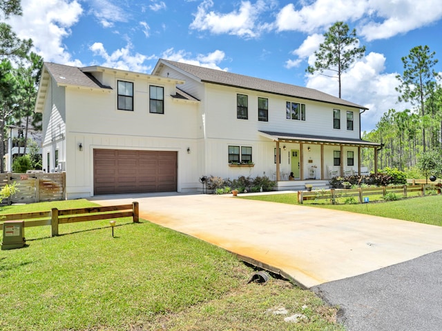 view of front of home featuring a garage and a front lawn