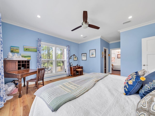 bedroom with ornamental molding, ensuite bath, hardwood / wood-style flooring, and ceiling fan