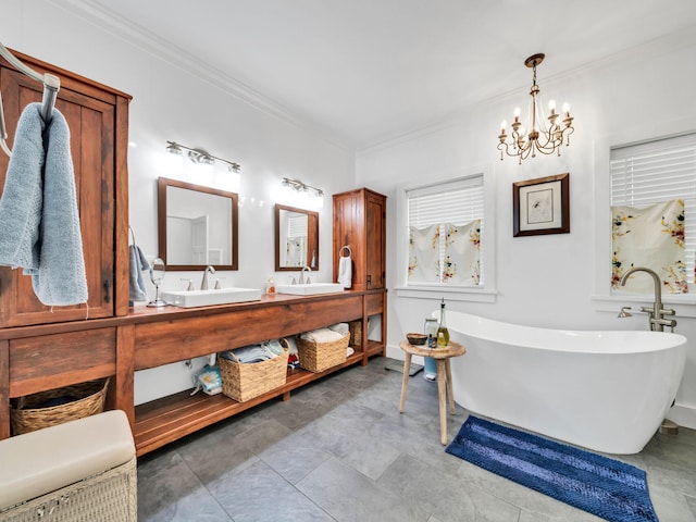 bathroom featuring ornamental molding, a washtub, vanity, and an inviting chandelier