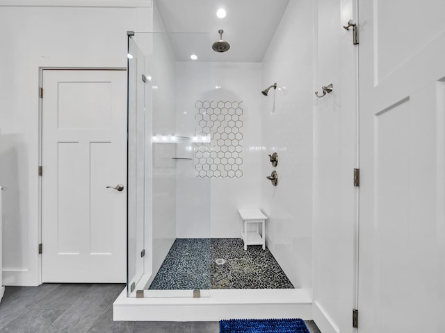 bathroom with tiled shower and tile patterned floors