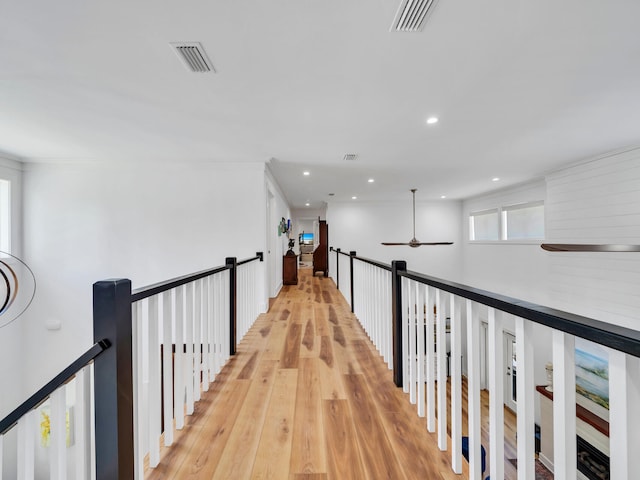 corridor with light hardwood / wood-style floors