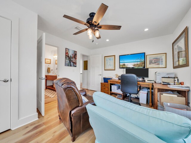 home office featuring ceiling fan and light hardwood / wood-style floors