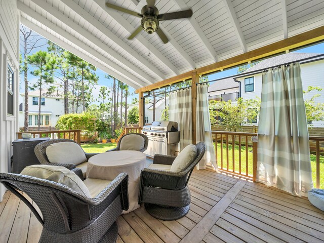 sunroom / solarium with a healthy amount of sunlight, lofted ceiling with beams, and ceiling fan