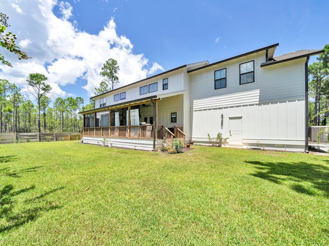 rear view of property with a lawn, a deck, and central air condition unit