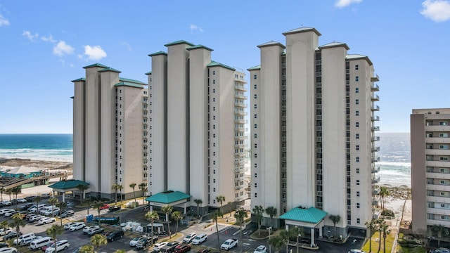 view of building exterior with a view of the beach and a water view