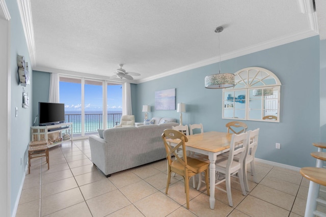 8573 Gulf Blvd Unit 703, Navarre, FL 32566 - dining room with a textured ceiling, crown molding, light tile patterned floors, ceiling fan, and baseboards