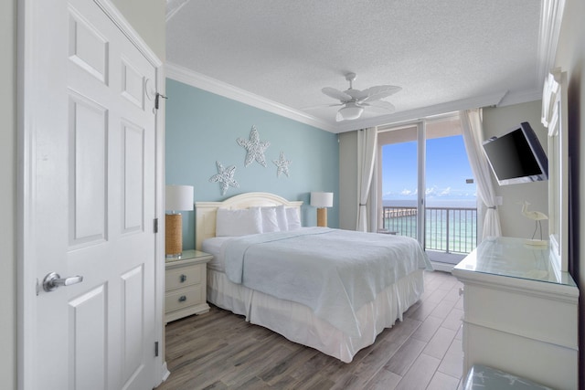 bedroom with hardwood / wood-style flooring, ceiling fan, ornamental molding, access to outside, and a textured ceiling