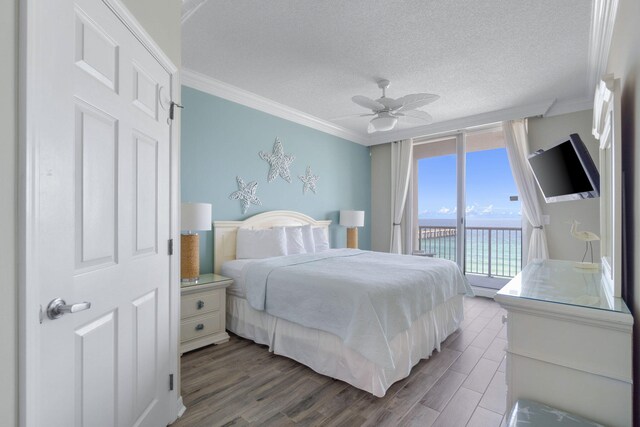 8573 Gulf Blvd Unit 703, Navarre, FL 32566 - bedroom featuring access to outside, ornamental molding, wood finished floors, a textured ceiling, and ceiling fan