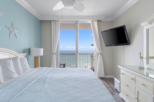 bedroom featuring crown molding, access to outside, a textured ceiling, ceiling fan, and wood-type flooring