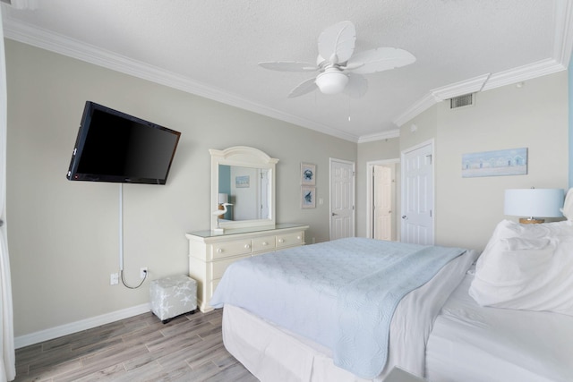 bedroom featuring ceiling fan, light hardwood / wood-style flooring, and ornamental molding