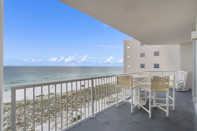 balcony featuring a water view and a beach view