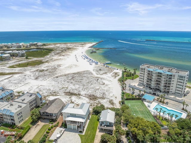 birds eye view of property featuring a water view and a beach view