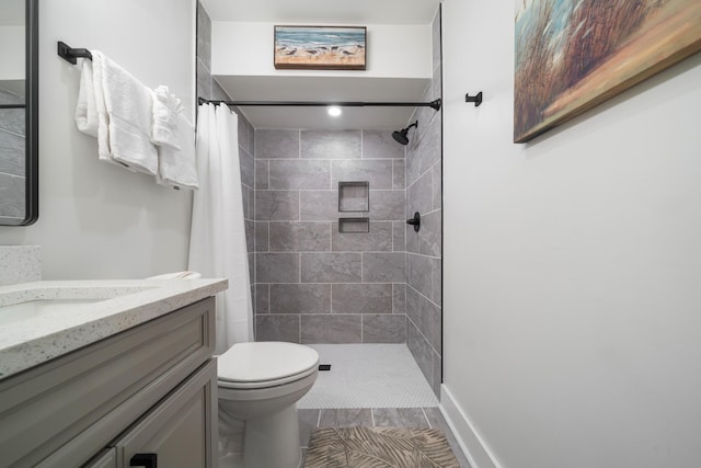 bathroom featuring vanity, toilet, and walk in shower