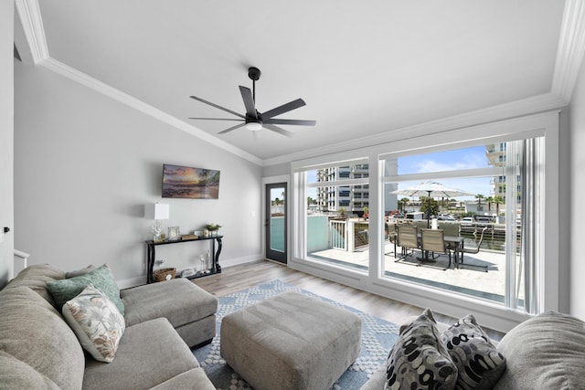 living room featuring ceiling fan, lofted ceiling, ornamental molding, and light hardwood / wood-style flooring