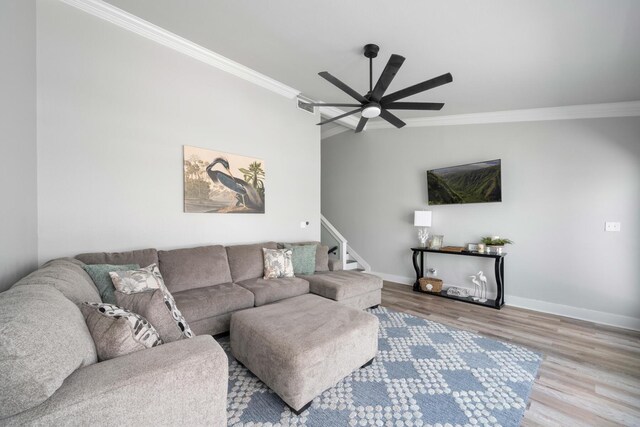 living room with lofted ceiling, crown molding, ceiling fan, and hardwood / wood-style flooring