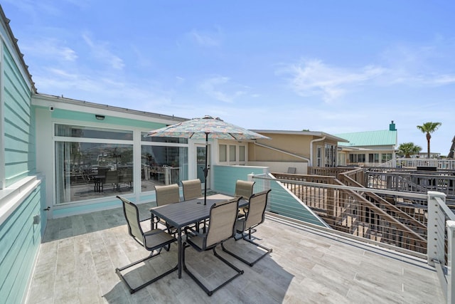 wooden deck with a hot tub and a patio area