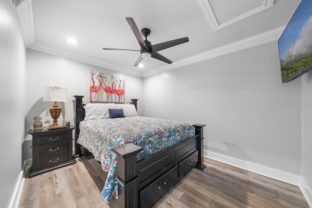 bedroom featuring ceiling fan, ornamental molding, and light hardwood / wood-style flooring