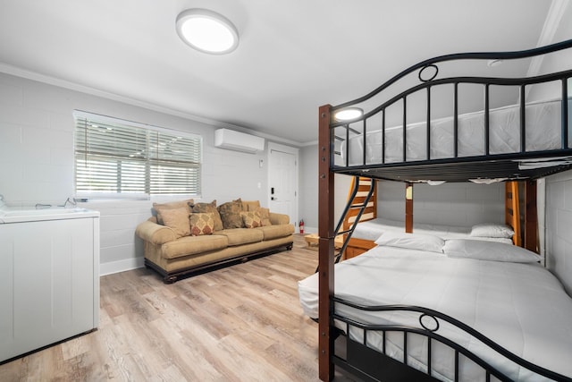 bedroom with ornamental molding, light hardwood / wood-style flooring, and an AC wall unit