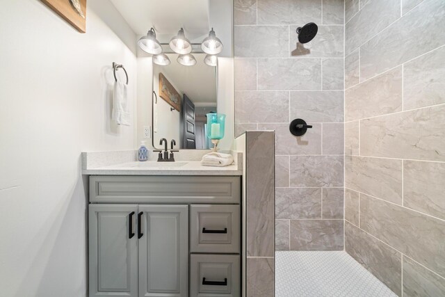 bathroom with vanity and a tile shower