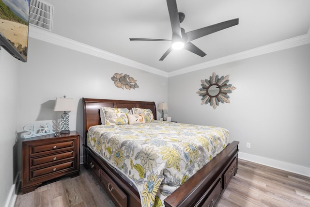 bedroom featuring crown molding, ceiling fan, and light hardwood / wood-style flooring