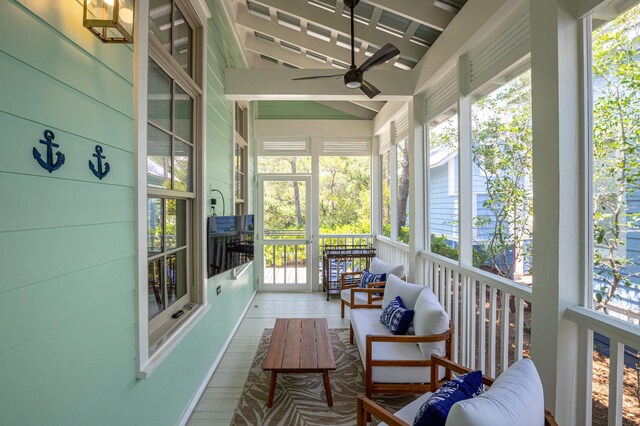 sunroom / solarium with a wealth of natural light and ceiling fan