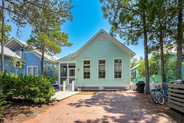 rear view of property featuring a sunroom