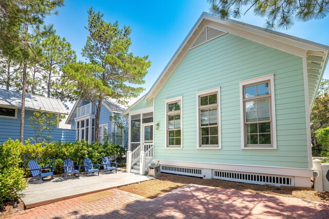 back of house with a patio area and a sunroom