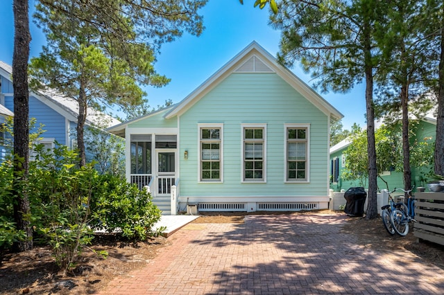 rear view of property with a sunroom