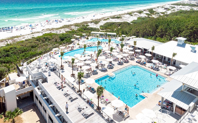 bird's eye view featuring a water view and a beach view