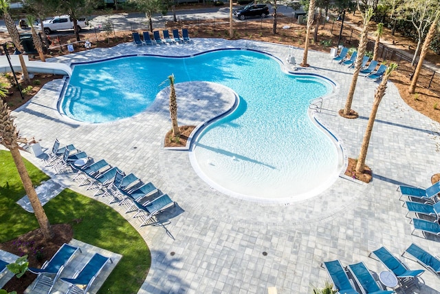 view of swimming pool featuring a water slide and a patio area