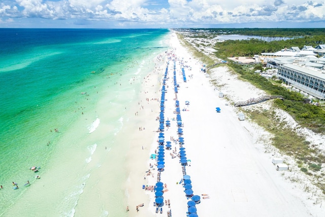 aerial view with a water view and a beach view