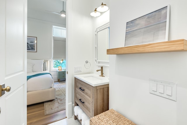 bathroom featuring hardwood / wood-style floors, vanity, and ceiling fan