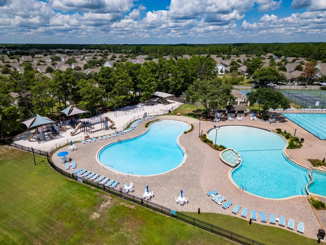 pool with fence and a patio
