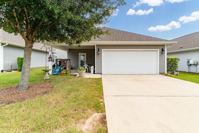 single story home featuring a garage and a front lawn