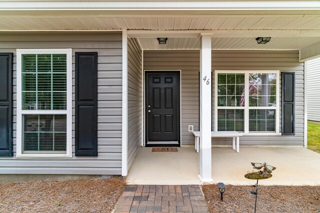 property entrance featuring covered porch