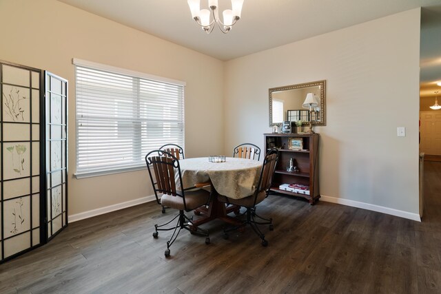 dining space featuring an inviting chandelier and dark wood-type flooring