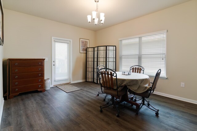 dining space featuring a notable chandelier and dark hardwood / wood-style floors