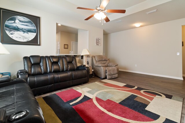 living room featuring ceiling fan and hardwood / wood-style flooring