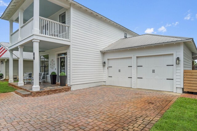 exterior space with a balcony and a garage