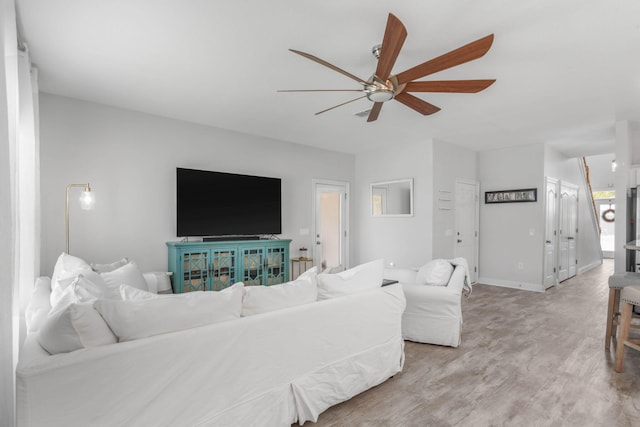 living room with ceiling fan and wood-type flooring