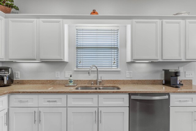 kitchen with white cabinets, sink, light stone counters, and dishwasher