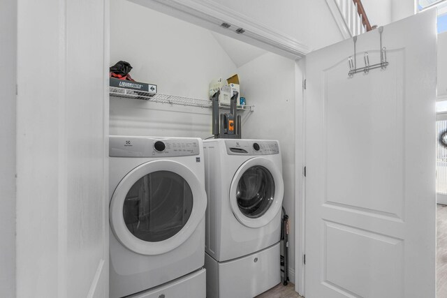 clothes washing area with separate washer and dryer