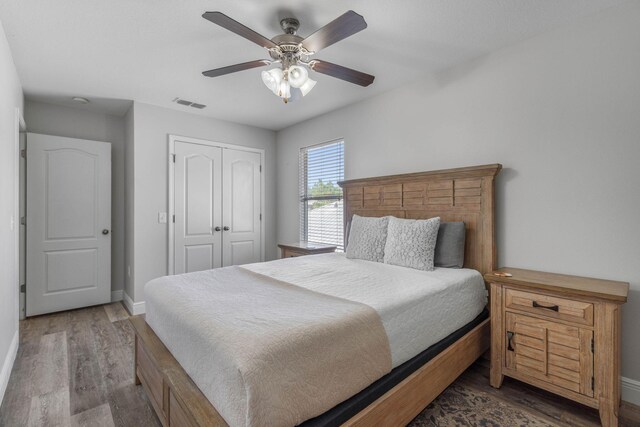 bedroom with a closet, ceiling fan, and wood-type flooring