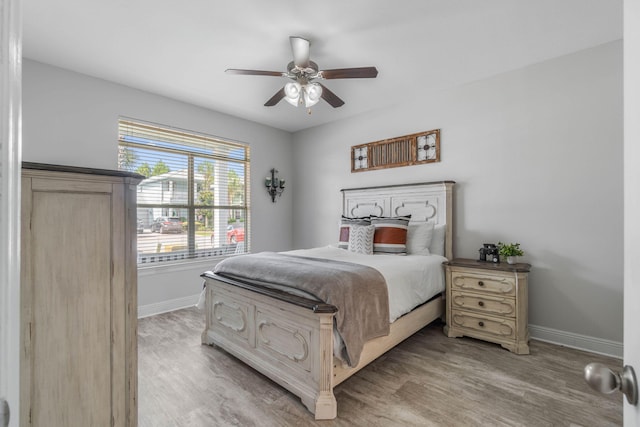 bedroom with ceiling fan and light wood-type flooring