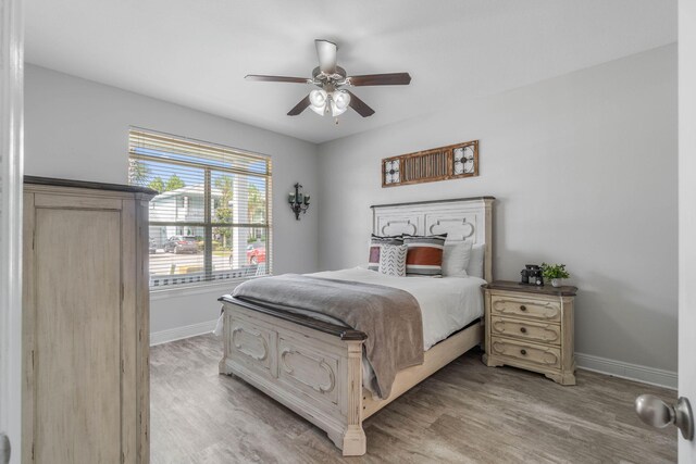 bedroom with ceiling fan and light hardwood / wood-style floors