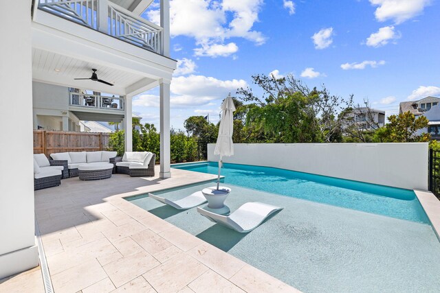 view of swimming pool featuring a patio, an outdoor hangout area, and ceiling fan