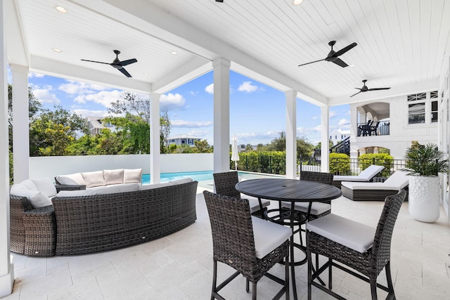 view of patio with a fenced in pool, an outdoor living space, and ceiling fan