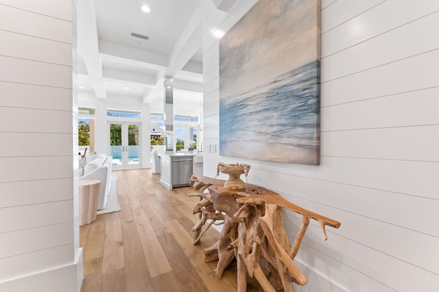 hall featuring beamed ceiling, light hardwood / wood-style floors, french doors, and coffered ceiling