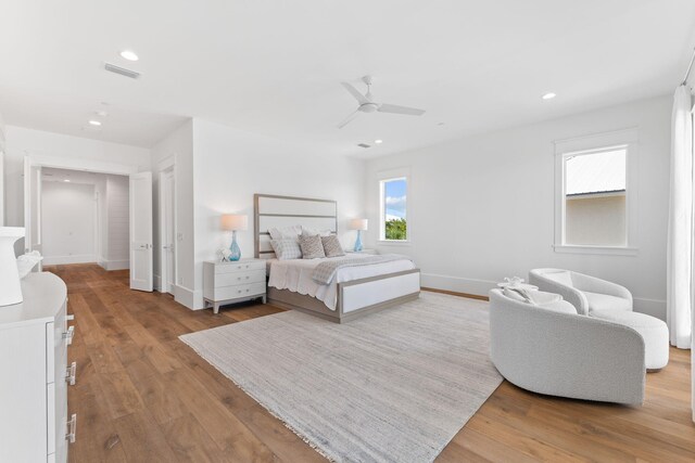 bedroom with ceiling fan and light wood-type flooring